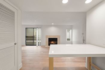 Room with table fireplace and sliding door